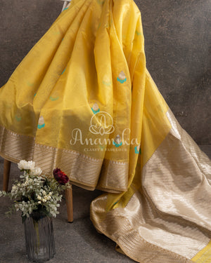 Yellow Chanderi pattu saree with a contrast blue blouse