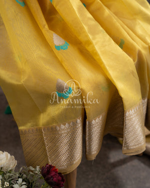 Yellow Chanderi pattu saree with a contrast blue blouse