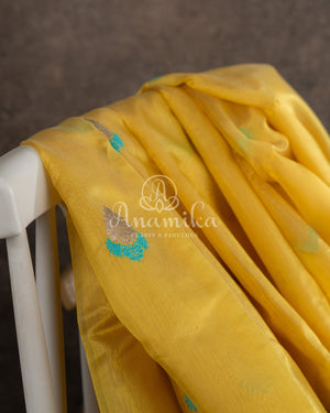 Yellow Chanderi pattu saree with a contrast blue blouse