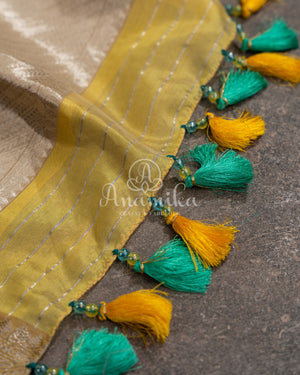 Yellow Chanderi pattu saree with a contrast blue blouse