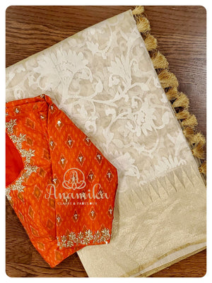 Cream Kora saree with orange ikkat blouse