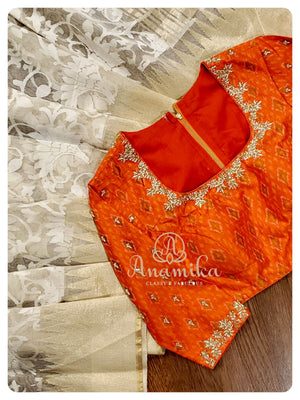 Cream Kora saree with orange ikkat blouse