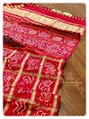 Red bandini gharchola with off white chikankari work blouse
