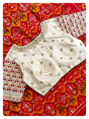 Red/Yellow Ikkat Patola saree with a contrast off white work blouse
