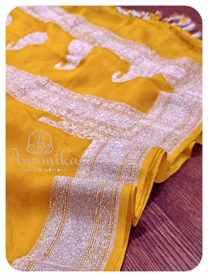 Yellow banarasi chiffon saree with pink blouse